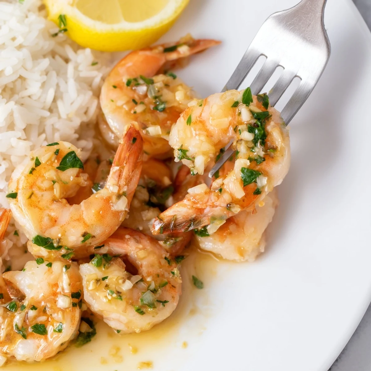 Flavorful 15-Minute Garlic Butter Shrimp garnished with parsley and lemon wedges.