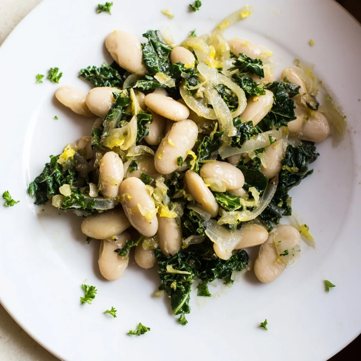 Steaming Garlicky Beans with Winter Greens, vibrant and colorful, served in a rustic bowl with fresh parsley.