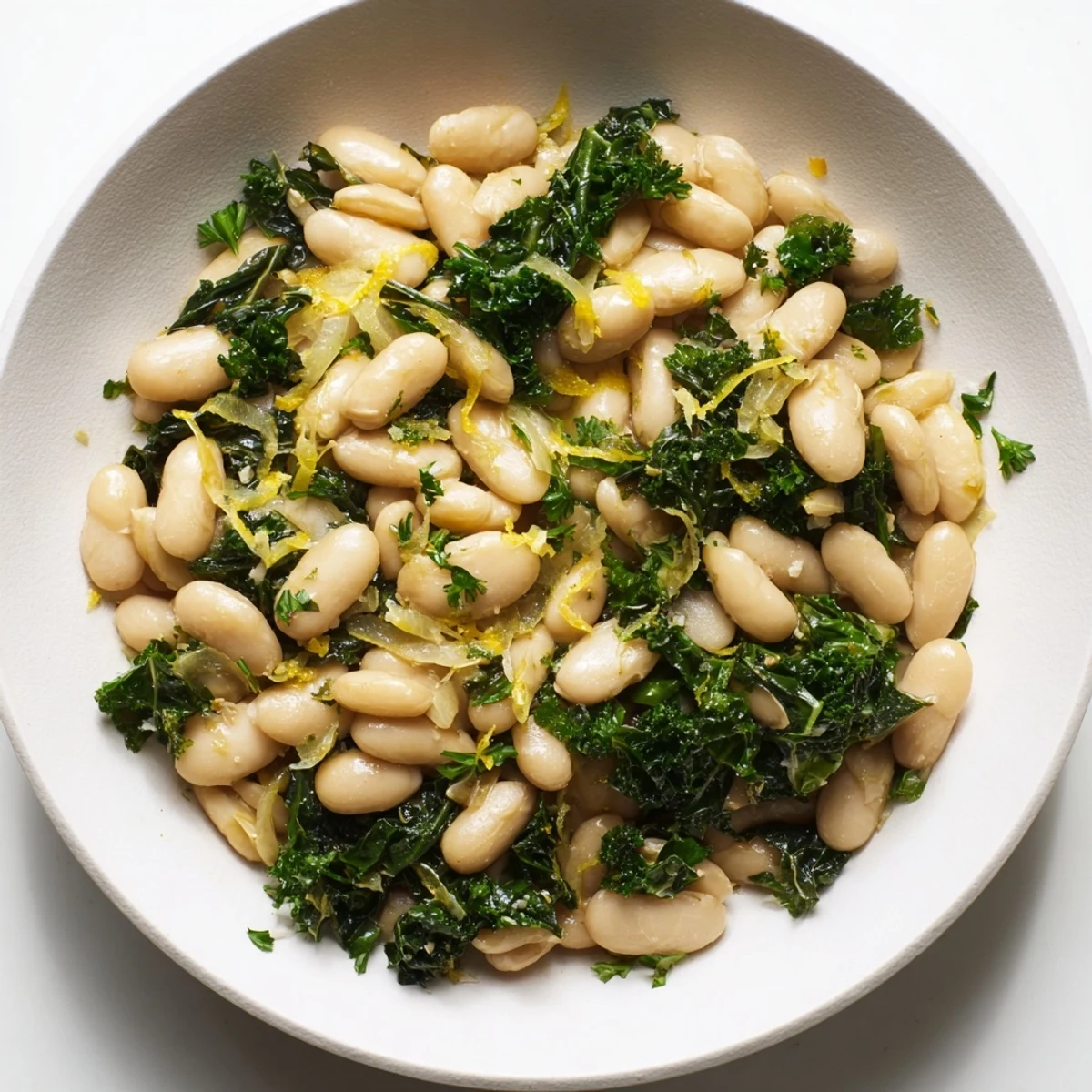A warm bowl of Garlicky Beans with Winter Greens, featuring tender greens and creamy beans, ready to eat.