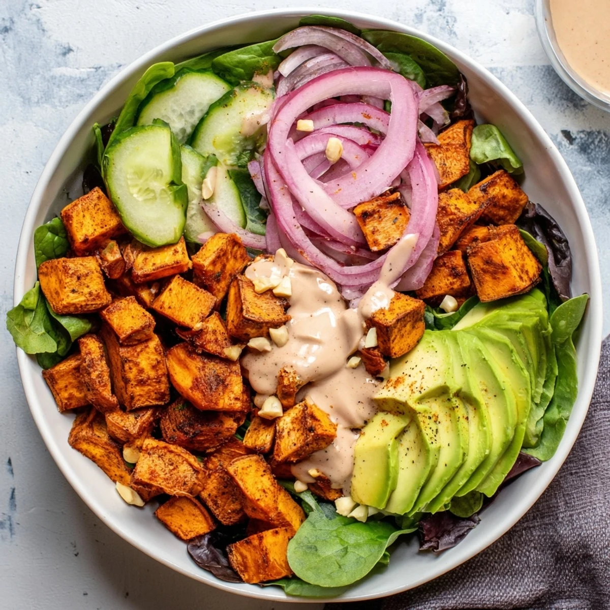 Imagine biting into this Spiced Peanut Sweet Potato & Radicchio Salad Bowl: a fresh, flavorful vegetarian meal.