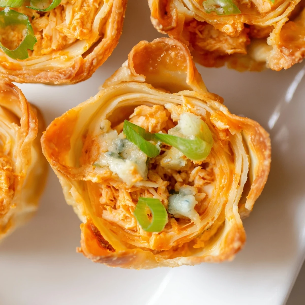 Spicy Buffalo Chicken Dip Pinwheel Wontons: imagine the savory filling encased in a flaky wonton crust.