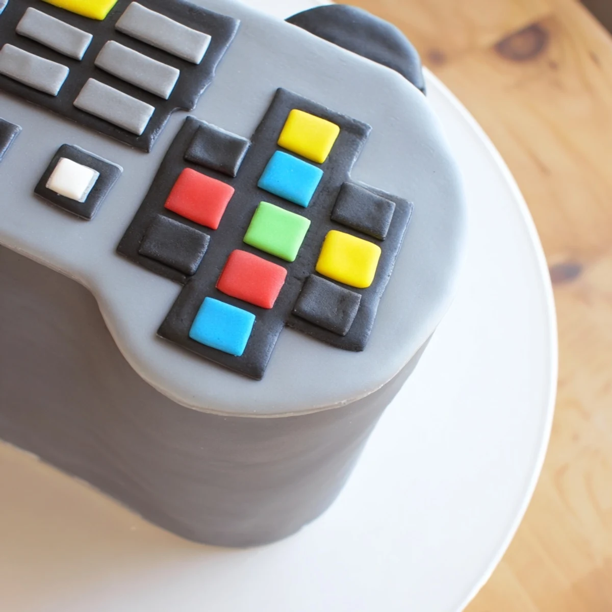 The finished video game controller cake is a delicious treat with a playful shape, ready for a gaming party.