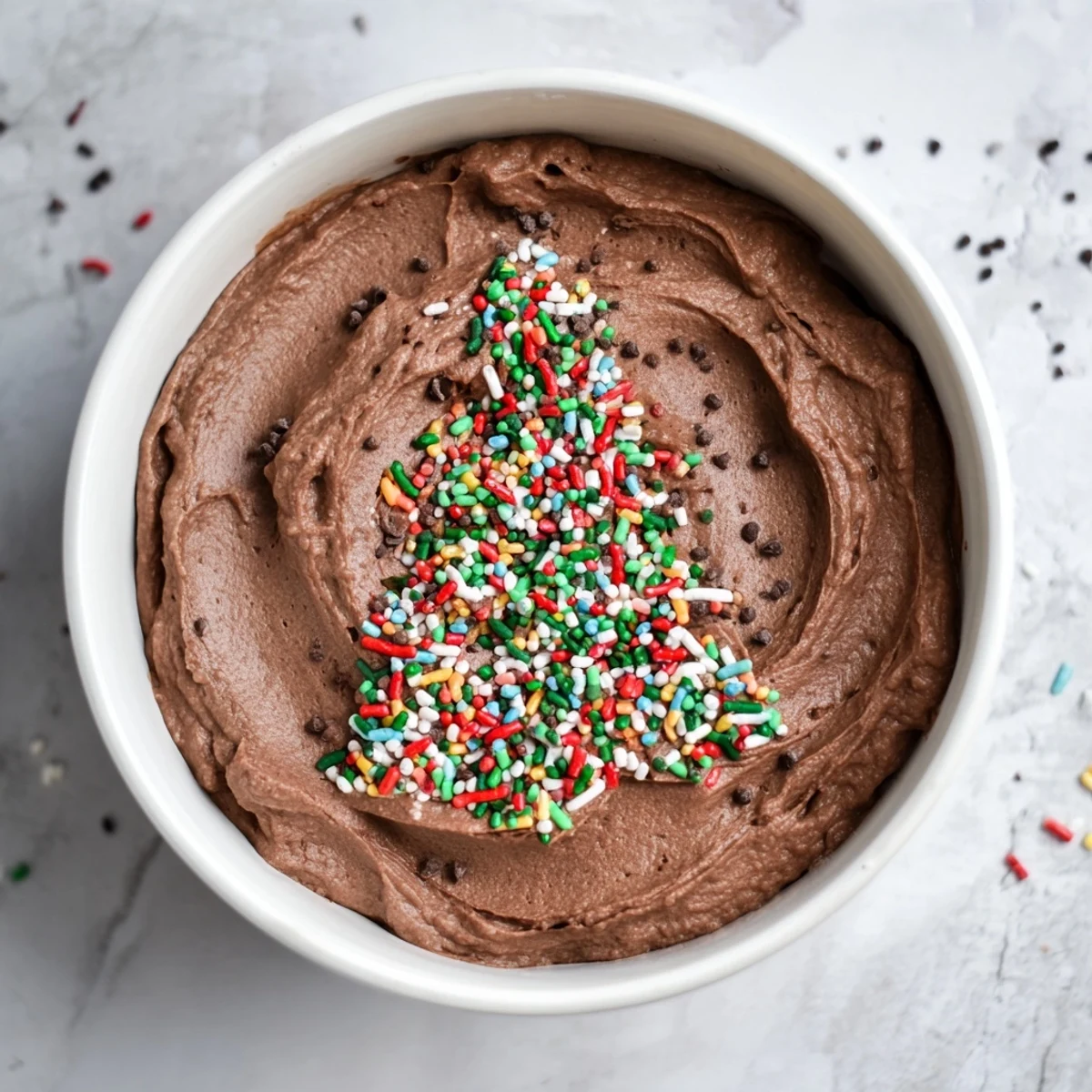 A scoop of rich, dark Festive Tree Brownie Dip, shimmering with holiday sprinkles, perfect for dipping and sharing around.
