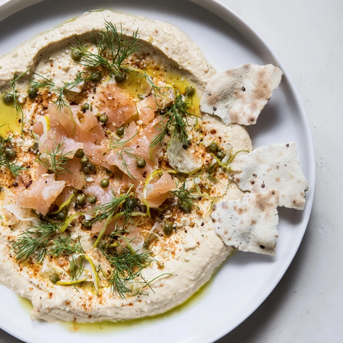 Perfectly plated The Driftwood Beach appetizer with flaky smoked fish, offering a refreshing sea-inspired flavor.