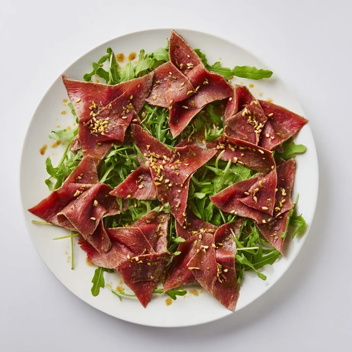 Savory and elegant: the Origami Fold Beef Appetizer, drizzled with marinade, ready for your guests.