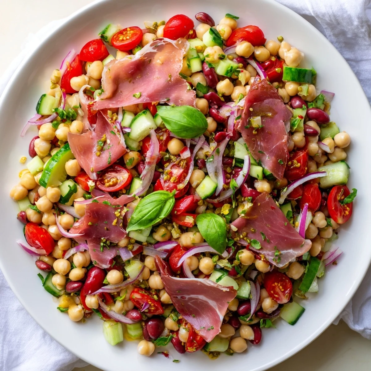 Hearty Dense Bean Salad with Prosciutto featuring fresh herbs and a zesty vinaigrette, perfect for serving.