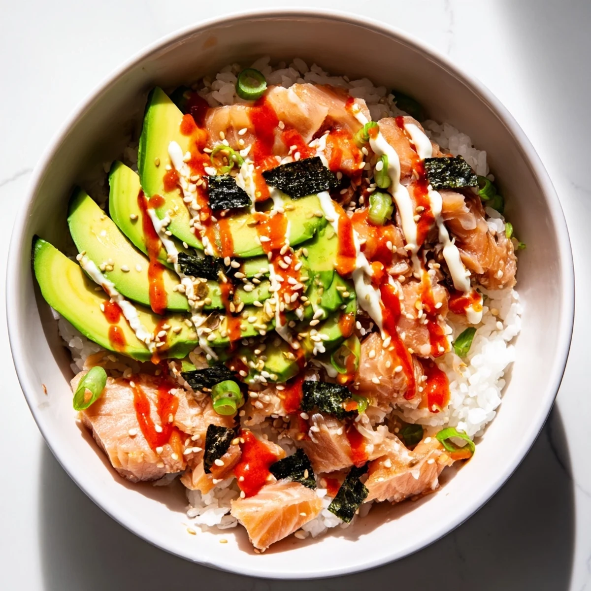 Freshly assembled Classic Salmon Rice bowl with seaweed, offering a delicious and easy Asian-inspired meal.