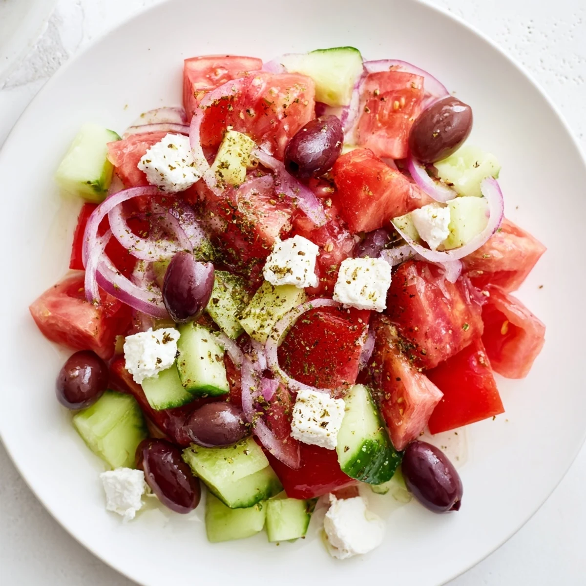 Bright, colorful Mediterranean salad with juicy tomatoes and creamy feta ready to enjoy.