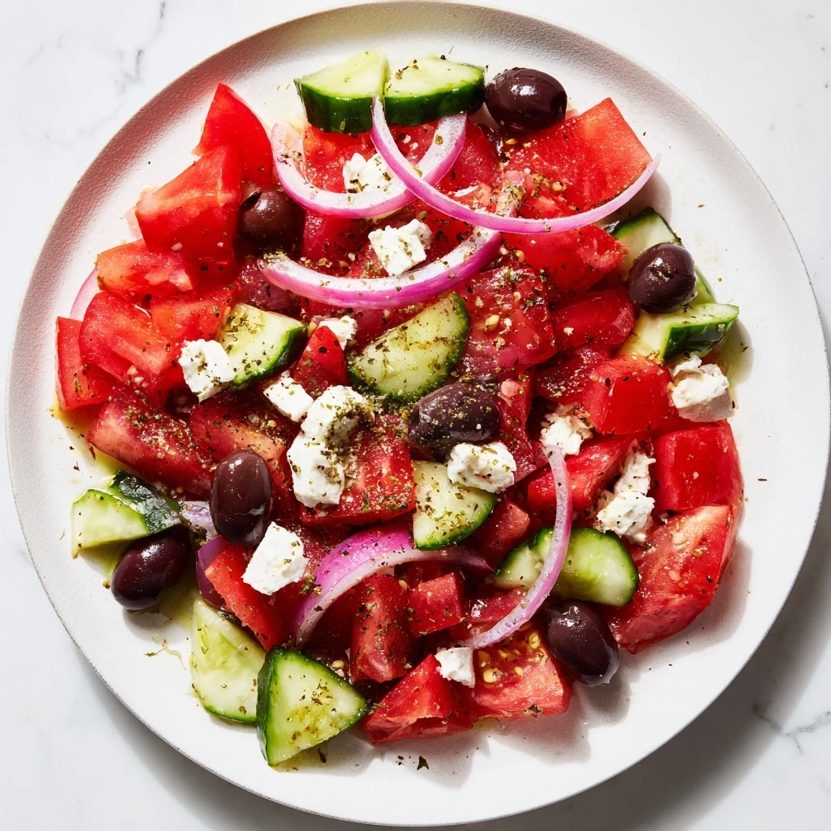 Tossed Mediterranean salad: a healthy dish with fresh cucumbers, olives, and crumbled feta cheese.