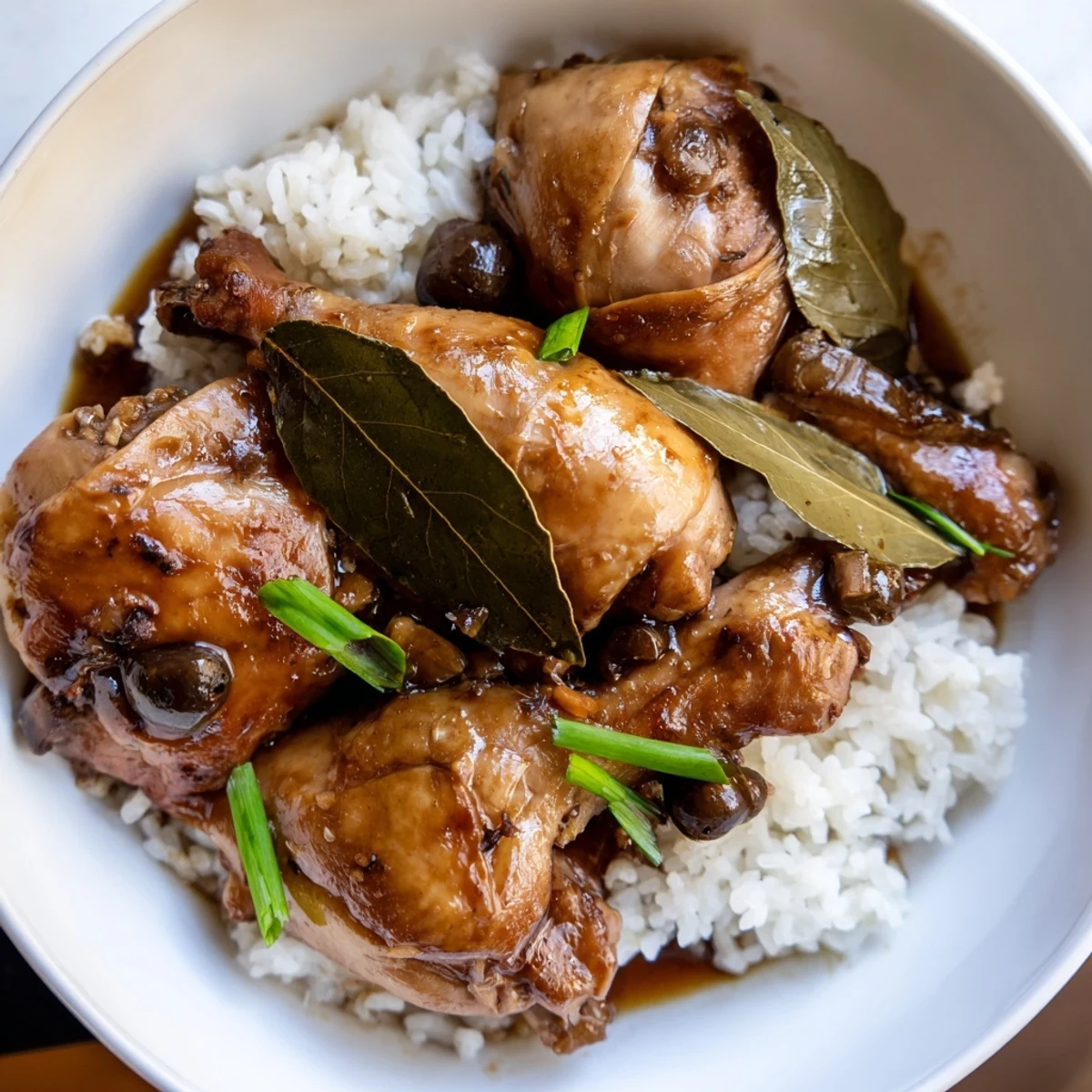Aromatic Filipino Chicken Adobo, simmered in vinegar and soy, is ready to savor with family.