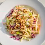 This colorful Crunchy Apple & Walnut Slaw with Blue Cheese showcases crunchy apples and toasted walnuts, ready to enjoy.