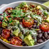 This colorful Black Bean and Veggie Bowl showcases ripe avocado, corn, and black beans, perfect for a quick, healthy lunch.