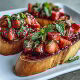 Fresh Strawberry Bruschetta with Balsamic and Mint, toasted baguette topped with juicy strawberries, mint, and tangy balsamic glaze for a summer appetizer.