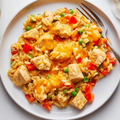 One-Pot Cheesy Chicken and Rice, a creamy, bubbling casserole for a satisfying dinner.