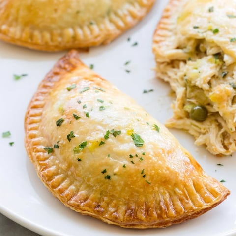 Golden, flaky Chicken Piccata Mini Hand Pies, filled with savory chicken and capers, are ready to enjoy as a snack!