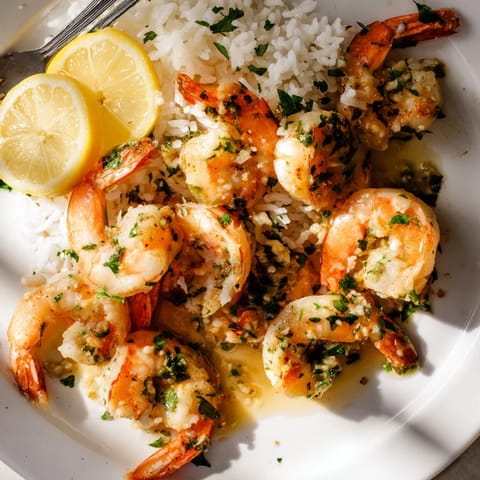 Quick and savory 15-Minute Garlic Butter Shrimp on a bed of fluffy rice.  