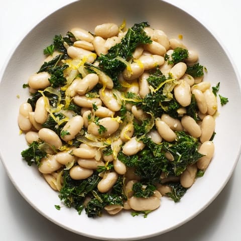 A warm bowl of Garlicky Beans with Winter Greens, featuring tender greens and creamy beans, ready to eat.