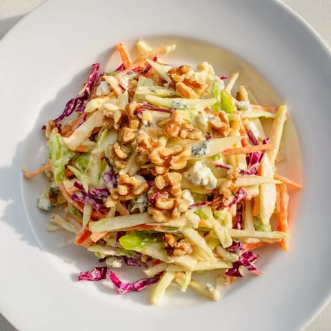 This colorful Crunchy Apple & Walnut Slaw with Blue Cheese showcases crunchy apples and toasted walnuts, ready to enjoy.