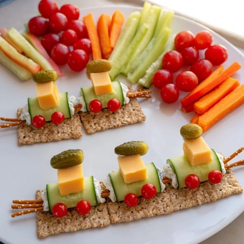 A colorful Choo Choo Train Snack Track: cheese, veggies, and fruit arranged playfully on crackers.