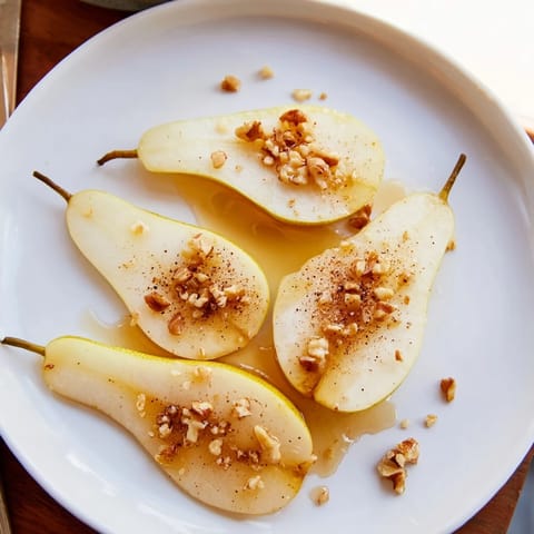 Delectable pear slices drizzled with honey, offering a delicate sweetness perfect for snacks.