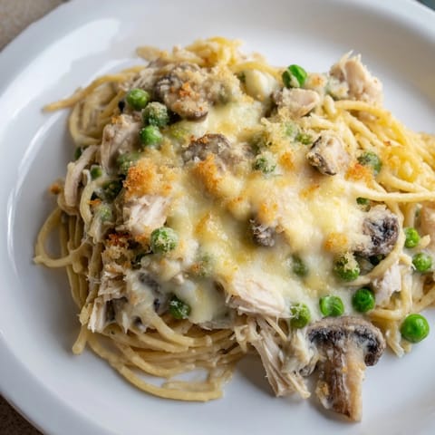 Golden-brown Turkey Tetrazzini boasts a creamy sauce with tender turkey and pasta, a true comfort dish.