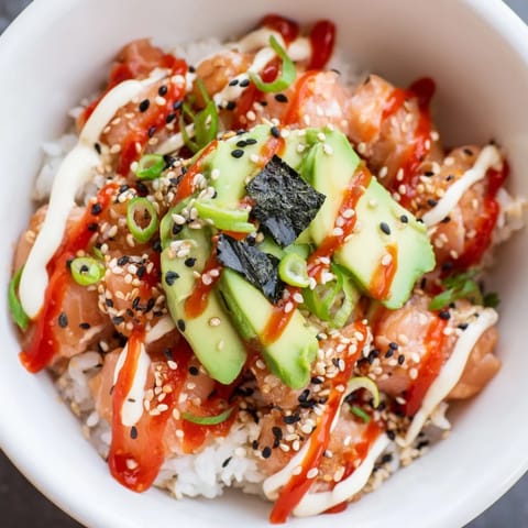 Enjoy the perfectly combined flavors in this colorful Classic Salmon Rice dish with avocado and sesame seeds.