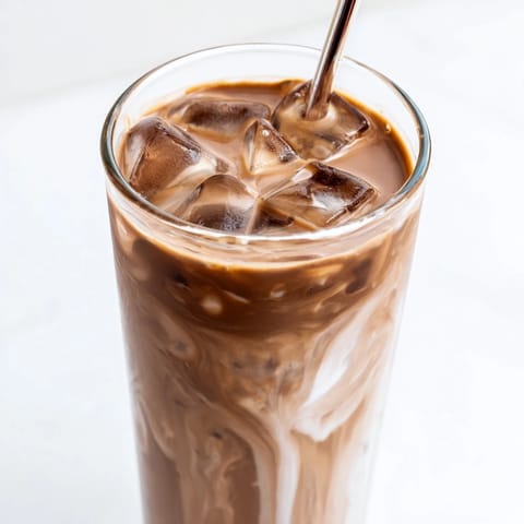 Creamy cold milk swirls into a rich Milo mixture in this 5-minute iced latte recipe.