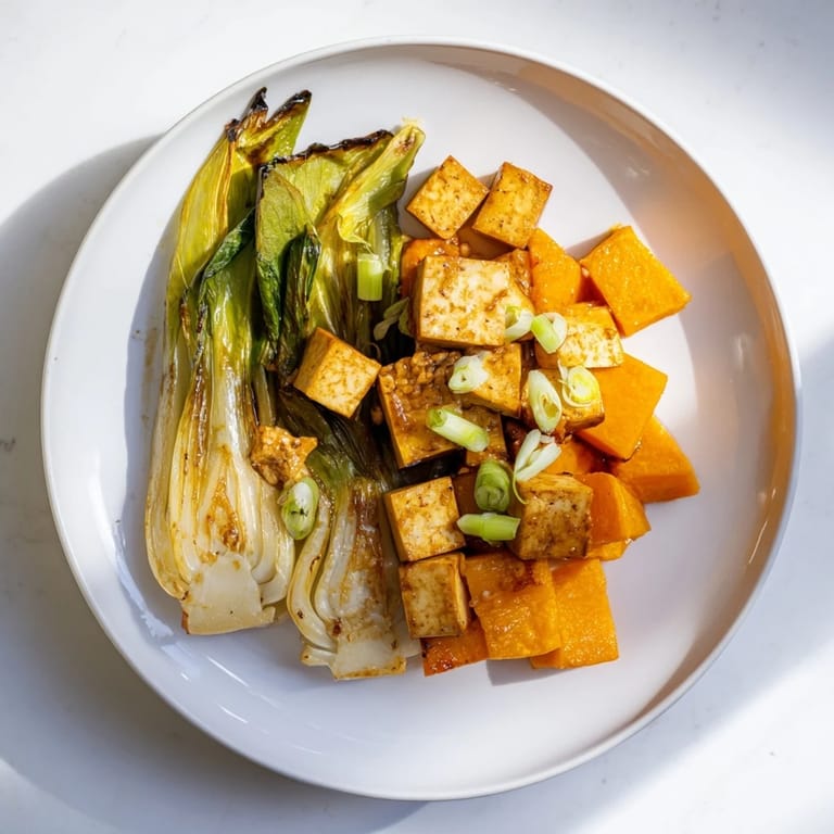 Savory miso glaze coats caramelized miso-glazed tofu and squash, a flavorful vegan main dish.