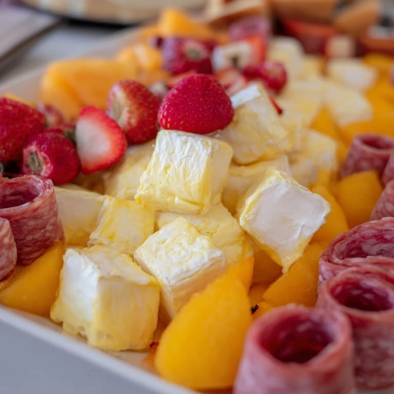 A delicious Flamingo Paradise Board overflowing with colorful fruits, cheeses, and meats, perfect for brunch.