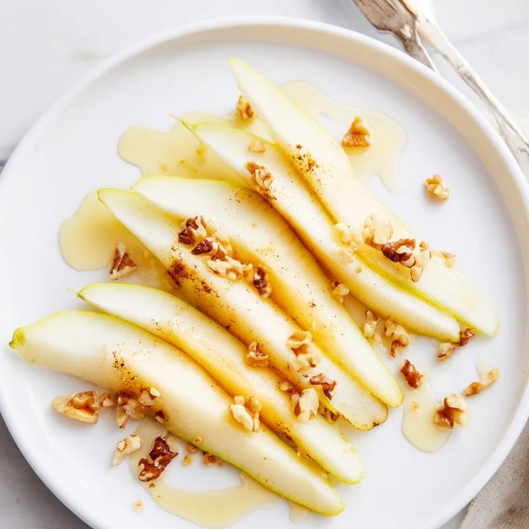 Freshly prepared pear slices with honey, a quick and elegant appetizer option, visually appealing.