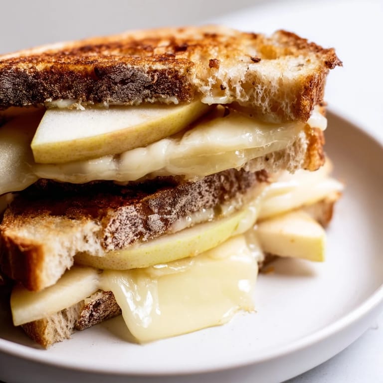 Crispy sourdough Brie and apple grilled cheese, a warm and comforting gourmet sandwich, perfect for lunch.