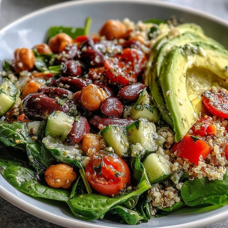 Served in a white ceramic bowl, the Three-Bean Power Bowl is garnished with cilantro.