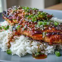 1. Honey garlic chicken with rice, featuring tender chicken thighs in a glossy, sweet-savory sauce served over fluffy jasmine rice.  